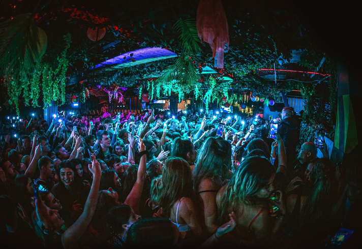 People dancing in a crowded nightclub.