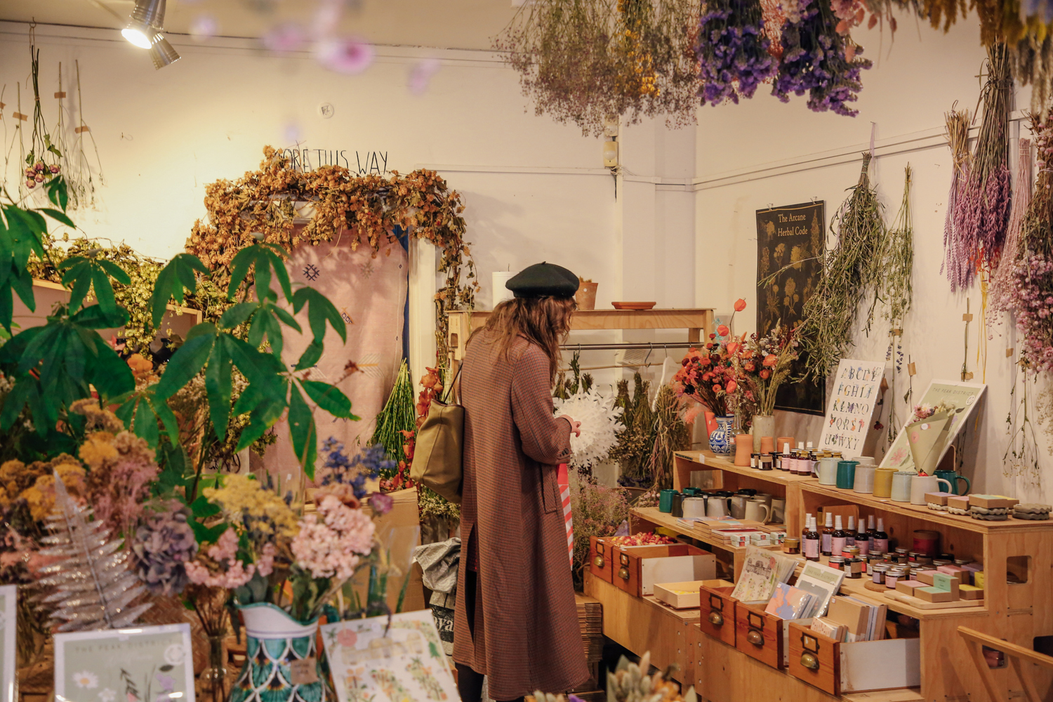 Inside the shop Moonko, on Division Street, a woman is browsing and looking at the displays.