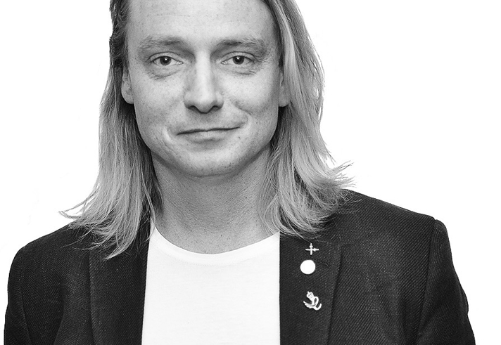 A black and white portrait of Sam Chapman.