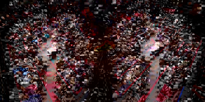 A packed house at the Crucible Theatre waits in anticipation for a classical concert to start. In the centre of the stage stands a grand piano.