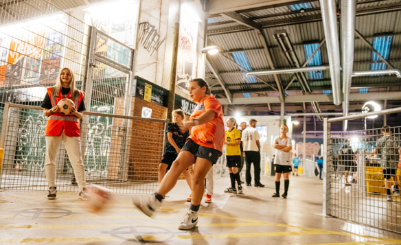 Children playing football at Yard Ball, an indoor football park.