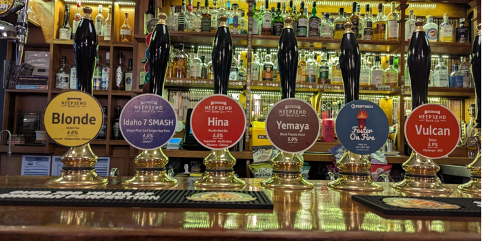The bar at The Wellington, with a row of traditional beer pumps.