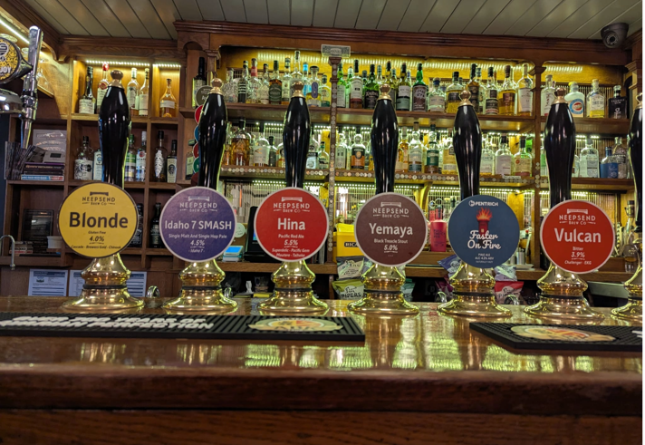 The bar at The Wellington, with a row of traditional beer pumps.