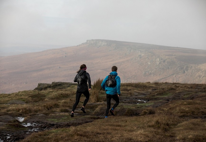 Two people on a city limits run route to Stanage Edge.