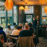 Several tables full of people enjoying their meals at Pellizco.