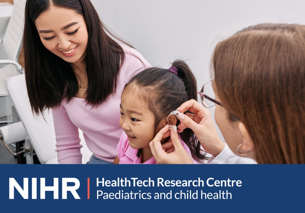 A healthcare professional fits a hearing aid onto a child’s ear while another adult sits nearby. The scene takes place in a clinical setting. At the bottom of the image, there is a banner with the text: ‘NIHR HealthTech Research Centre – Paediatrics and child health.’