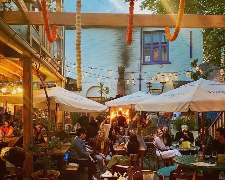 The courtyard at Haggles Coner, filled with people dining.