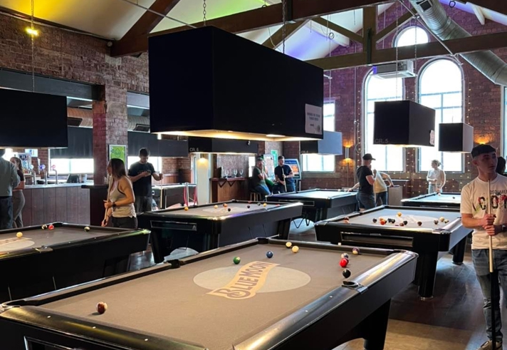 People playing pool at The Common Room.