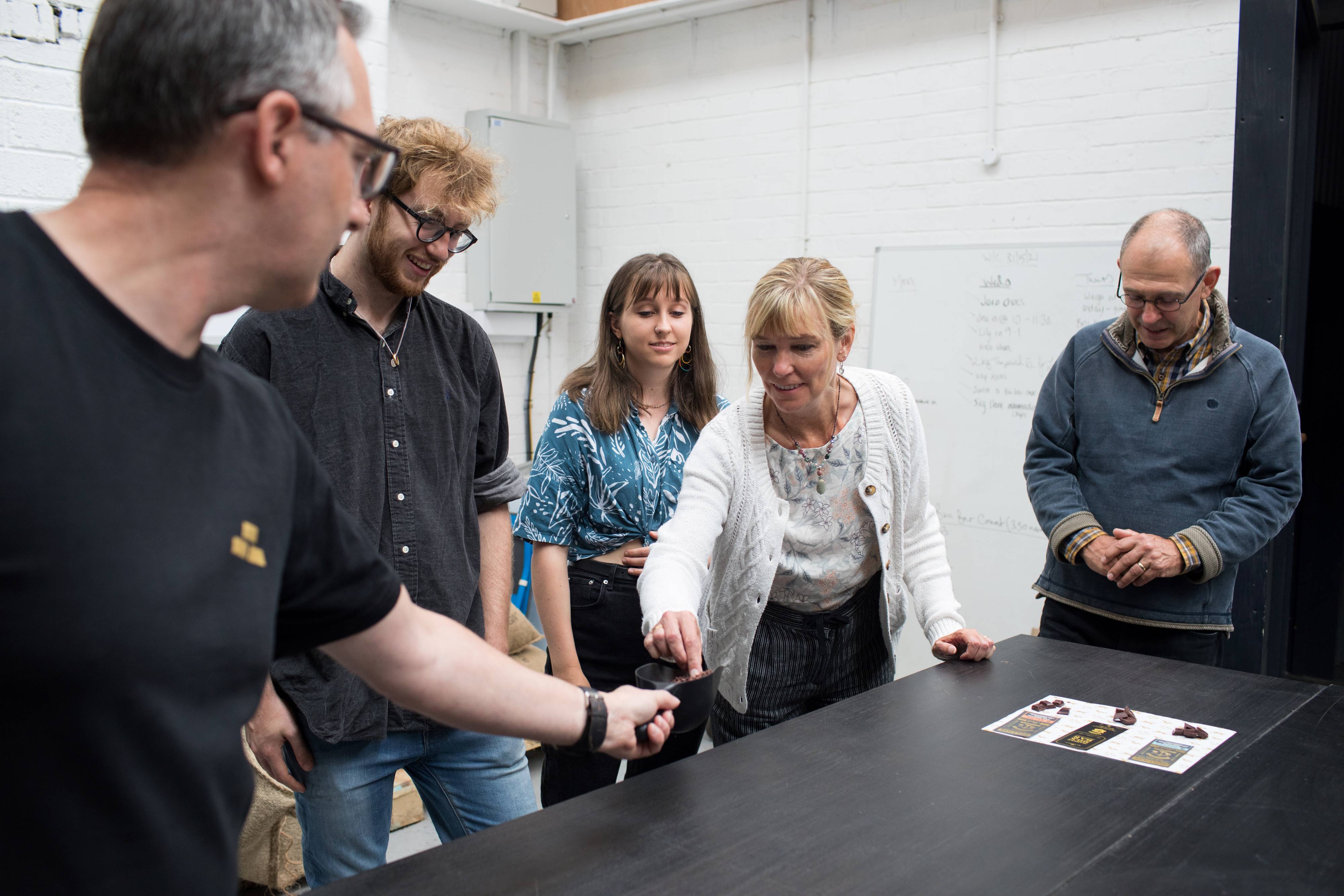 A small group of people tasting samples of chocolate on the Bullion Chocolate Tour.