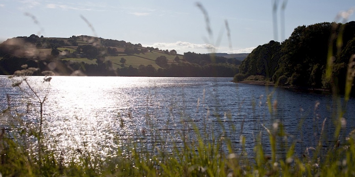 Bradfield Reservoir with the sun glinting off the water. 