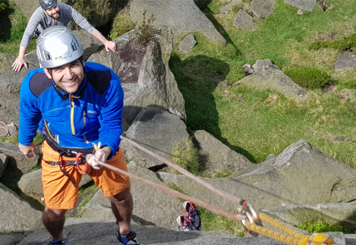 A person learning rock climbing.