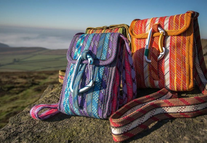Two bags sat on a rock in the countryside.