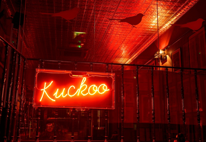 A red neon sign that reads 'Kuckoo'.