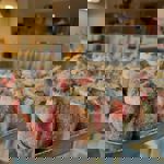 A tray of doughnuts filled with jam and cream.