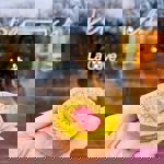 A hand holding an individual tart.