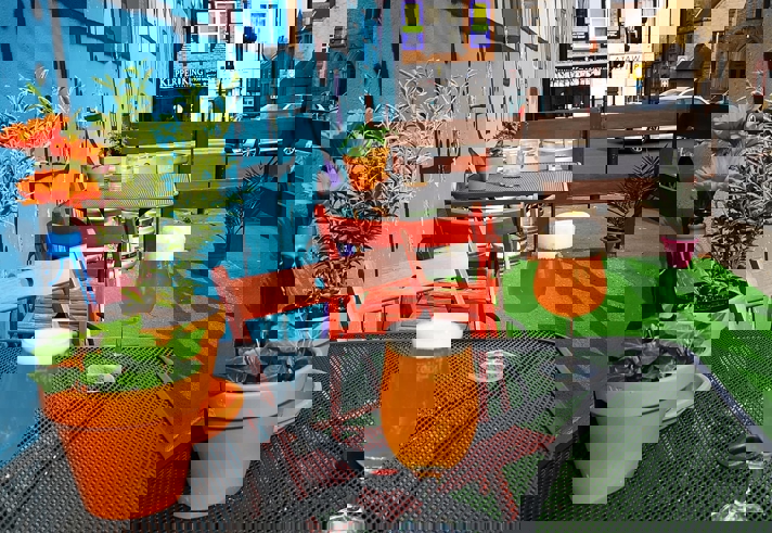 A table outside Jabbarwocky, with glasses of beer and pot plants.