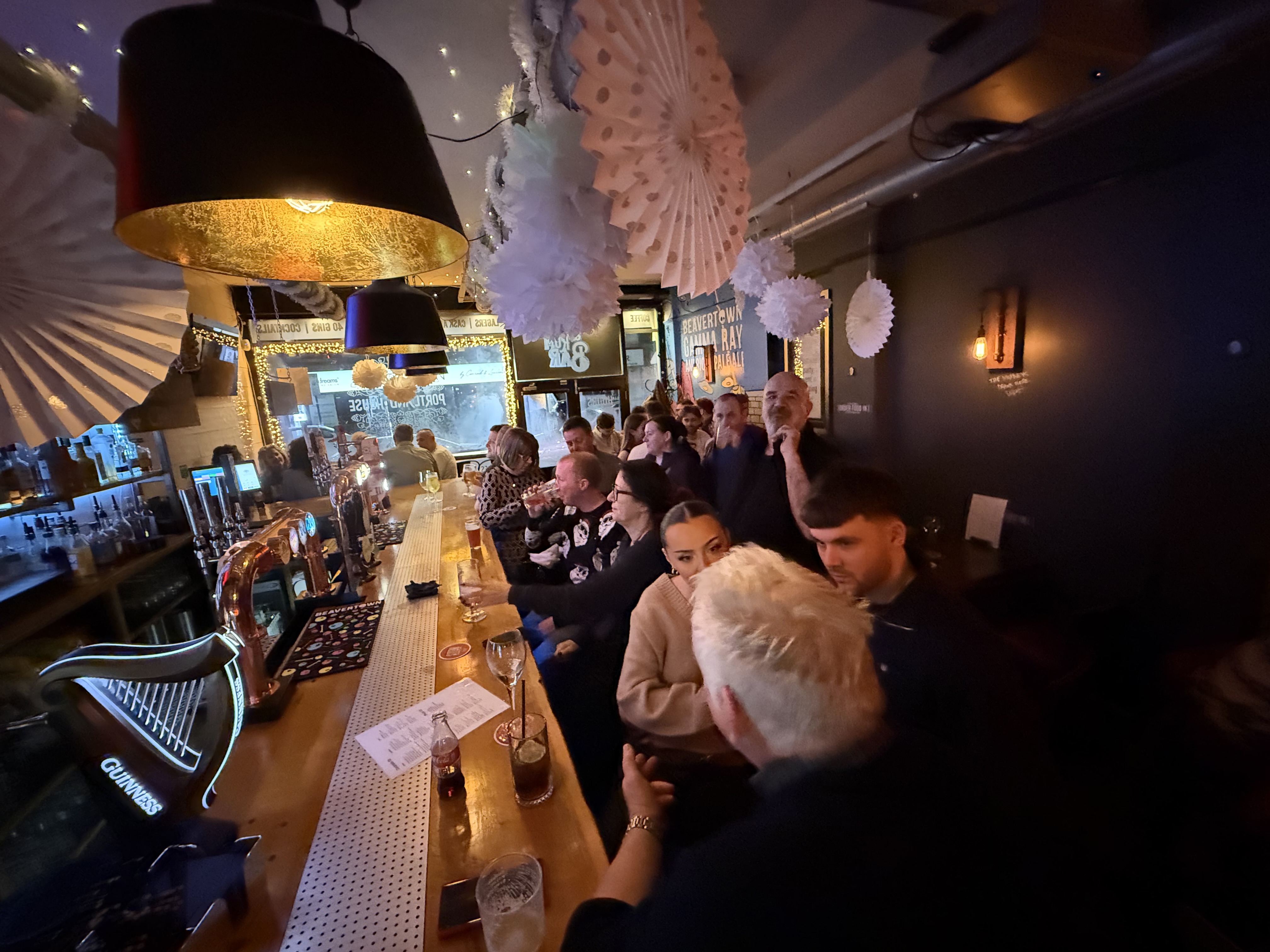 The interior of a lively and packed bar.