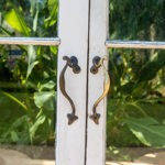 A close-up of one set of doors in the Glass House at Sheffield Botanical Gardens.