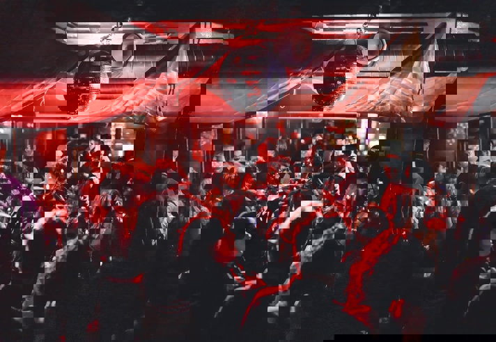 Disco ball above people dancing at Panke Social 