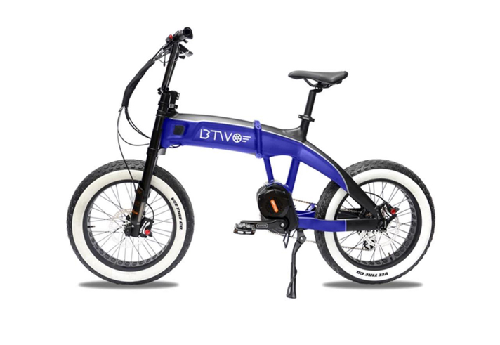 A blue, electric bike with white walled tyres.