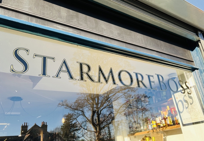 A windoe with Starmore Boss painted on it in gilded lettering.