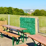outdoor seating area at Dukes in the Park with the city in the distance 