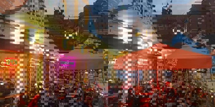 People dining outside at Terrace Goods, in the evening.