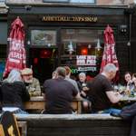 Groups of people sat drinking outside The Abbeydale Tap 